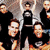 Static 50x50 pixel icon showing a group of people in black clothing against a light background with visible dithering and low-resolution rendering artifacts.