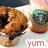 A pixelated image of a hand holding a muffin with visible blueberries, with the text 'YUM.' in red below.