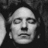 Black-and-white pixelated portrait of a person with closed eyes on left, green background with 'Alan Rickman' text on right.