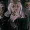 repeated figures in dark robes with white hair and beards, some covering their mouths