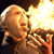 Pixelated figure with light hair exhaling or shouting toward a bright, glowing light source on the right side of the frame.