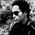 Black-and-white photo of a person with dark hair and sunglasses on left; red and white text 'LET LOVE RULE', '20 YEAR', 'RE RELEASE', 'LENNY KRAVITZ .COM' on black background.