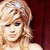 Static pixelated image of a woman with blonde hair against a dark red background, rendered in low-resolution 256x256 pixels.