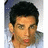 Pixelated image of a person with dark hair and light skin wearing a light-colored shirt, next to black text on white background.