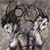 Two pixelated figures with dark hair and light skin stand side-by-side against a gray background, one holding an object near the other's face.