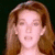 A pixelated image of a person with long brown hair against a dark background, paired with text elements on the right side.