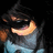 Pixelated image of a character with dark hair and light blue clothing holding an orange crescent-shaped object against black background.