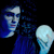 Pixelated figure with blue hair and light skin holds a glowing white object against a dark background.