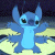 Pixelated blue cartoon character with large ears, black eyes, and a light blue torso stands against a dark background with yellow ground.