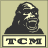 Pixelated black-and-white icon of a roaring gorilla head above a rectangular banner with "TCM" text on a beige background.