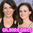 A pixelated image of a woman with long brown hair smiling, wearing a dark top and pink text overlay reading "GLAMOREGIRLS".
