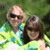 Two pixelated figures in a green and blue outdoor setting, one wearing sunglasses and light-colored clothing, the other with dark hair and brown tones.