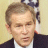 nine pixelated images showing a man in a dark suit and white shirt with an American flag background, each with distinct text overlays