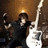 Pixelated image of a person playing white electric guitar with red text reading Frank, ROCKS, My Chemical Romance on black background.
