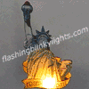 Animated statue of liberty figure with torch and tablet, displaying sequential color changes from yellow to blue to red.