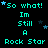 Cyan text on black background reads "So what! Im Still A Rock Star" with scattered blue and dark blue stars, repeated in a pattern