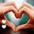 Animated icon shows hands forming a heart shape with green and white interior, transitioning to star-shaped hand gesture with pink accents.