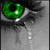 A split- image with a green eye and tear on the left, green smoke on the bottom left, and text on the right