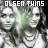 Black-and-white photo of two women with layered necklaces, overlaid text "OLSEN TWINS" in various colors across six