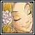 Pixelated close-up of a person's face with closed eyes, wearing a white flower in hair against a yellow background.