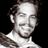 Static 48x48 pixel icon showing a grayscale close-up of a person's face and upper shoulders against black background with visible dithering and low-resolution artifacts.