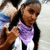 A person with long dark hair wearing a purple scarf and white top, making a hand gesture with fingers extended, in a pixelated animation.