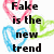 Pixelated text reads 'Fake is the new trend everyone seems to be in style' over layered heart outlines in pink, blue, and green on white background.
