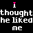 A black background displays repeated text in white and pink pixelated font, with the phrase "I thought he liked me" arranged in a pattern