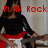 A woman with long dark hair plays a white electric guitar, wearing a black top and red skirt, with red text overlays changing across frames.