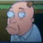 Pixelated cartoon character with large blue eyes and a receding hairline, wearing a light blue collared shirt against a dark background.