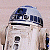 Pixelated static image of a white and blue droid with black accents, likely from Star Wars, displayed on a light gray background.