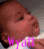 A pixelated image of a baby with text overlays in pink, showing variations in background and text content across frames.