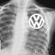 X-ray chest image with Volkswagen logo overlaid on the left chest, showing ribcage and lung fields in grayscale.