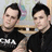 Two identical men in black shirts pose side-by-side against a blurred background with red text reading "and the record keeps playin" and "the same old song."