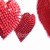 Three red heart shapes with pixelated textures, varying in size and shade, arranged on a white background.
