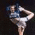 A pixelated image of a person in motion holding a blue object against a dark background.