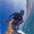 Pixelated static image of a hand holding a dark object against a blue gradient background with vertical light streaks.