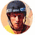 A circular icon shows a person wearing a dark helmet with blue and white accents, yellow shirt, and visible straps; the right side of the face is partially cropped.