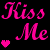Pixelated pink text "Kiss Me" with three colored hearts on black background, transitioning between heart colors in animation.