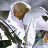 Pixelated static icon of a character in motion with blurred background elements and visible dithering patterns.