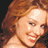 Static 48x48 pixel icon showing a close-up of a person with long wavy red hair and light skin, cropped to the upper shoulders against a dark background.