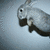 A gray rabbit with black eyes and nose appears in four showing movement from left to right against a light blue background