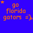 Blue background with orange text reading 'go florida gators =)' and small orange stars scattered across the image.