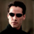 Static pixelated image of a person with dark hair and sunglasses against a neutral background, rendered in low resolution.
