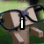 Pixelated image showing a hand holding glasses with an 'i' symbol, a cheese-like character in superhero attire, and partial text reading 'ude bo'.