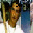 Pixelated static image of a figure with long hair holding a flag, standing before partial text reading "MY BEST".