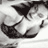 Static grayscale icon depicting a stylized bikini top with curved straps and a central triangular cutout, rendered in low-resolution pixel art style on white background.