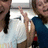 A pixelated image shows two people in a room with green and gray backgrounds, one person making a peace sign gesture.