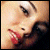 A four- shows close-up facial features: top-left mouth with red lips, top-right eye with black eyeliner, bottom-left nose and mouth with red lips, bottom-right empty gray