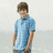 A pixelated image of a person in a light blue polo shirt and dark pants standing against a pale background, with pink text on black